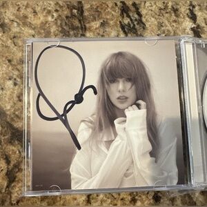 The Tortured Poets Department CD with hand-signed photo insert